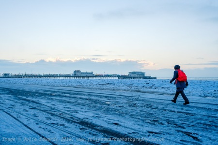 Commuters walk along the icy promenade as Snow hits the South East of the UK on Friday 1 February 2019